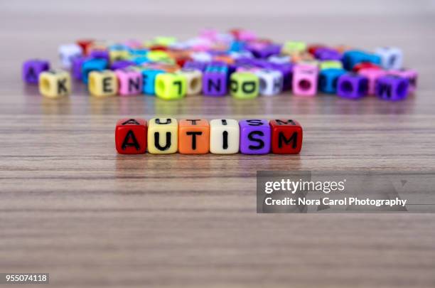 autism word and alphabet letter beads - autism awareness stock pictures, royalty-free photos & images