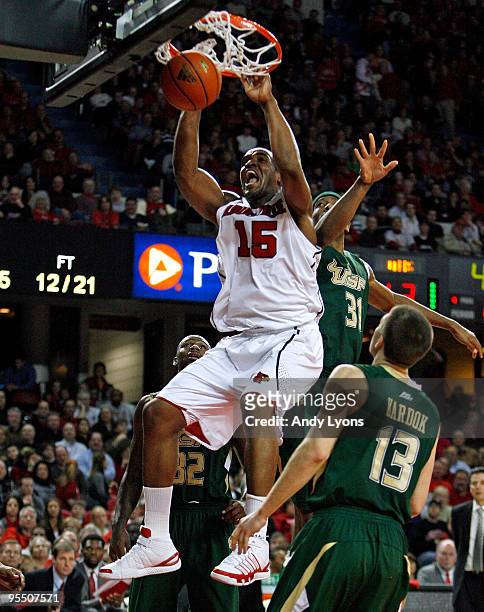 Samardo Samuels of the Louisville Cardinals dunks the ball against Jarrid Famous and Ryan Kardok of the South Florida Bulls during the Big East...