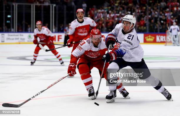 Nichals Hardt of Denmark and Dylan Larkin of United States battle for the puck during the 2018 IIHF Ice Hockey World Championship group stage game...