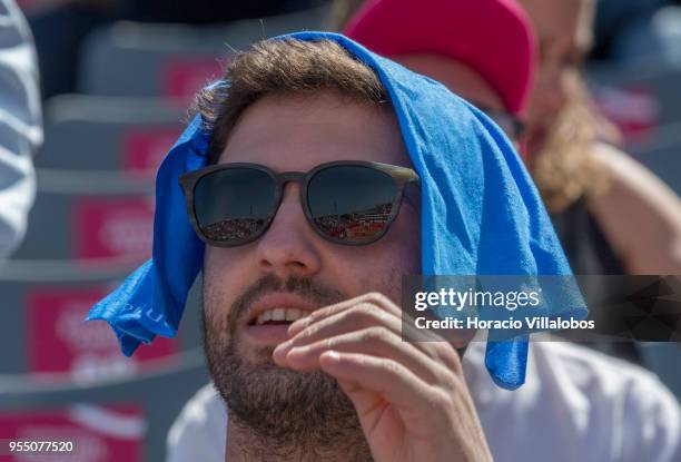 Spectator covers his head with a cloth while waiting for the start of the first semifinals match between Stefanos Tsitsipas of Greece and Joao Sousa...