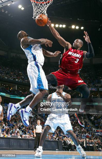 Emeka Okafor of the New Orleans Hornets and Dwyane Wade of the Miami Heat fight for a rebound on December 30, 2009 at the New Orleans Arena in New...