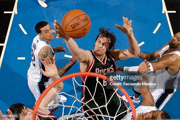 Andrew Bogut of the Milwaukee Bucks reaches for a rebound against the Orlando Magic during the game on December 30, 2009 at Amway Arena in Orlando,...