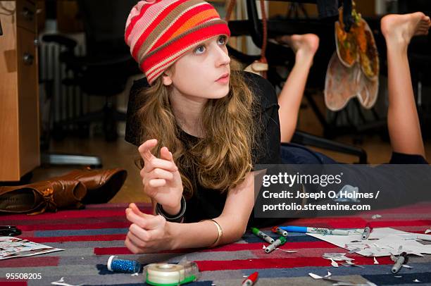 girl does homework on the floor - joseph o holmes stock pictures, royalty-free photos & images