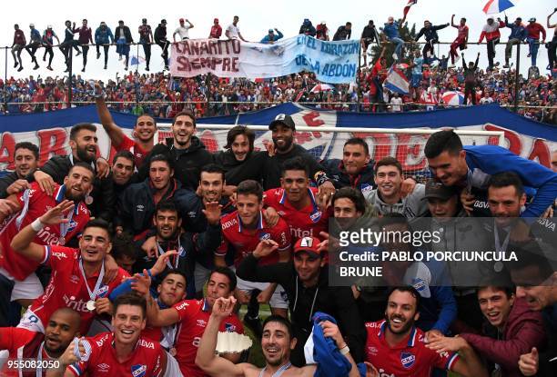 Uruguayan Nacional footballers celebrate after winning Uruguayan Apertura tournament at Jardines del Hipodromo stadium in Montevideo on May 5, 2018.