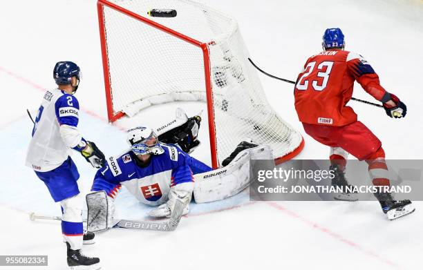 Czech Republic's Dmitrij Jaskin strikes to score the game-winning goal past Slovakia's goalie Marek Ciliak during the 2018 IIHF Men's Ice Hockey...