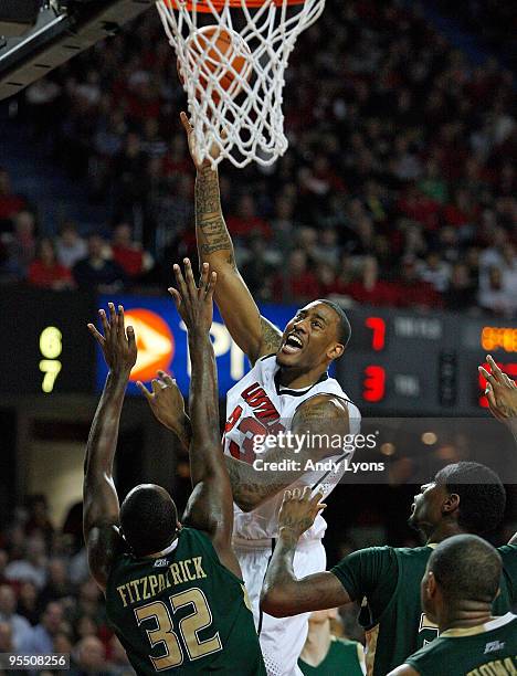 Terrence Jennings of the Louisville Cardinals shoots the ball against Toarlyn Fitzpatrick of the South Florida Bulls during the Big East Conference...