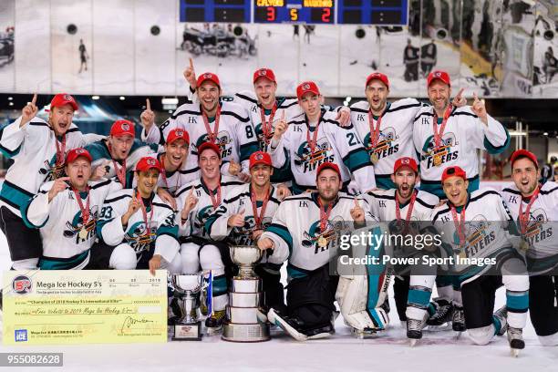 Cathay Flyers squad poses for photos with the champion's trophy during the Mega Ice Hockey 5s International Elite Final match between Nordic Vikings...