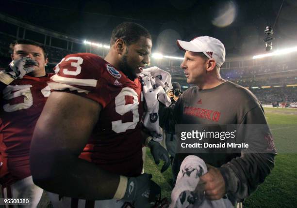 Ndamukong Suh talks with Head Coach Bo Pelini of the University of Nebraska Cornhuskers after their team's 33-0 victory against the University of...