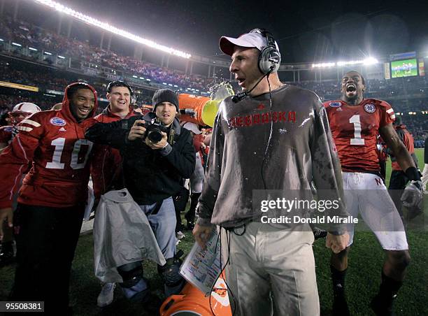 Head Coach Bo Pelini of the University of Nebraska Cornhuskers looks around after having sport drink dumped on him after their team's 33-0 victory...