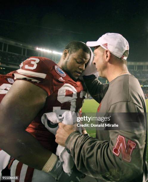 Ndamukong Suh talks with Head Coach Bo Pelini of the University of Nebraska Cornhuskers after their team's 33-0 victory against the University of...