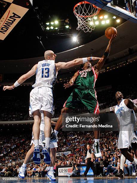 Jodie Meeks of the Milwaukee Bucks takes the ball to the basket against Marcin Gortat of the Orlando Magic during the game on December 30, 2009 at...