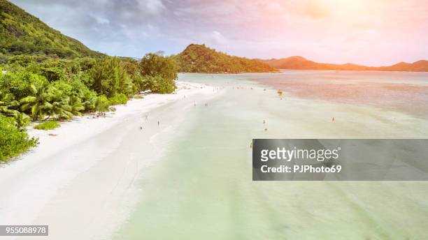 aerial view of anse volbert with tourists - praslin - seychelles - pjphoto69 stock pictures, royalty-free photos & images