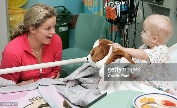 Kim Clijsters of Belgium smiles at a young patient while on a visit to the Royal Brisbane Childrens Hospital on December 31, 2009 in Brisbane,...