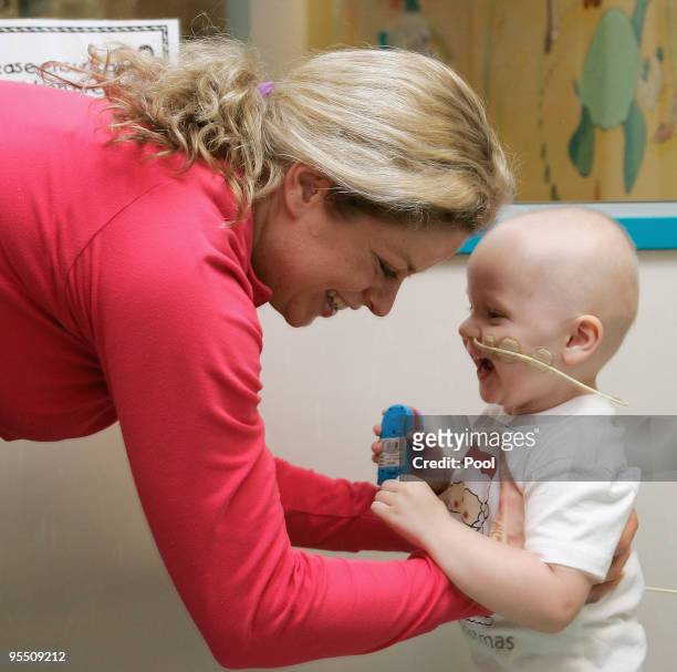Kim Clijsters of Belgium interacts with a young patient while on a visit to the Royal Brisbane Childrens Hospital on December 31, 2009 in Brisbane,...