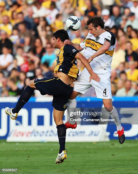 Jonathan McKain of the Phoenix heads the ball over Nik Mrdja of the Mariners during the round 21 A-League match between the Central Coast Mariners...