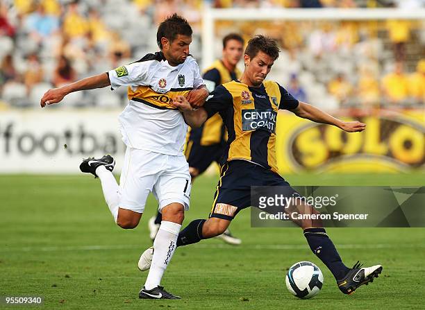 Vince Lia of the Phoenix contests the ball with Nicky Travis of the Mariners during the round 21 A-League match between the Central Coast Mariners...