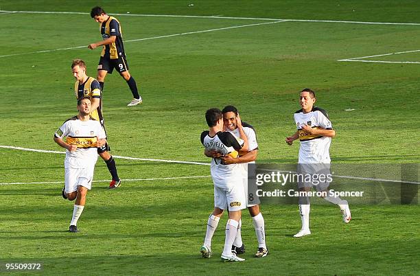 Paul Ifill of the Phoenix celebrates with team mates after scoring a penalty goal during the round 21 A-League match between the Central Coast...