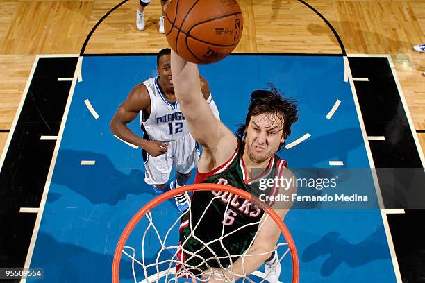 Andrew Bogut of the Milwaukee Bucks goes up to slam dunk against the Orlando Magic during the game on December 30, 2009 at Amway Arena in Orlando,...