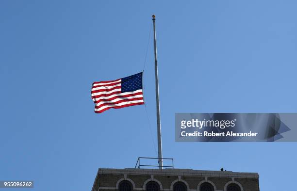 An American flag flies over the U.S. Deparatment of Agriculture South Building in Washington, D.C. The flag was flown at half-mast to honor former...