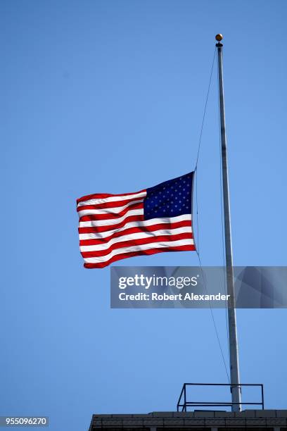 An American flag flies over the U.S. Deparatment of Agriculture South Building in Washington, D.C. The flag was flown at half-mast to honor former...