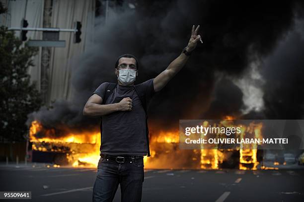 File picture taken on June 13, 2009 shows smoke billowing from a burning bus as a supporter of defeated Iranian presidential candidate Mir Hossein...