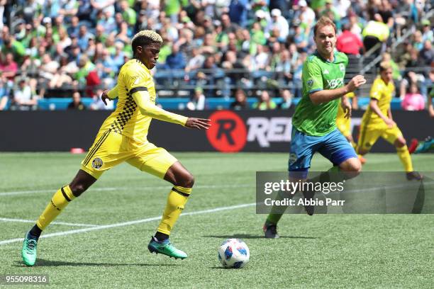 Gyasi Zerdes of Columbus Crew dribbles with the ball against Chad Marshall of Seattle Sounders in the first half during their game at CenturyLink...