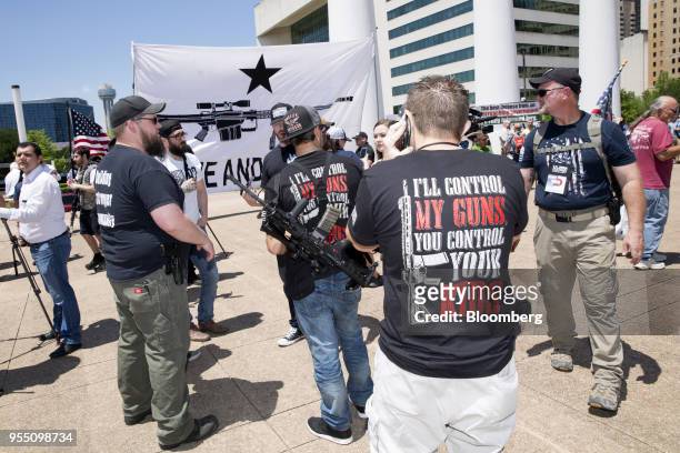 Demonstrators open carry rifles during a pro-gun rally on the sidelines of the National Rifle Association annual meeting in Dallas, Texas, U.S., on...