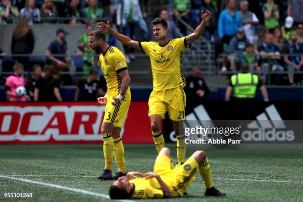 Josh Williams and Alex Crognale of Columbus Crew celebrate following their 0-0 draw to the Seattle Sounders during their game at CenturyLink Field on...