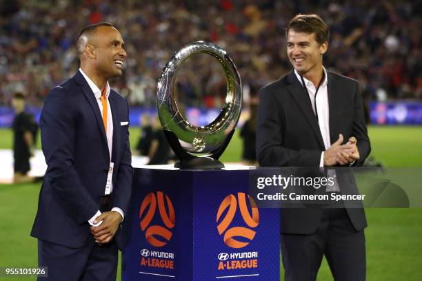 Former players Joel Griffiths of the Jets and Archie Thompson of the Victory bring the A-League Champions trophy onto the field during the 2018...