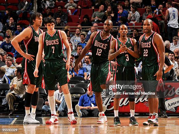 Andrew Bogut, Ersan Ilyasova, Luc Richard Mbah a Moute, Brandon Jennings and Michael Redd of the Milwaukee Bucks wait for play to resume during the...