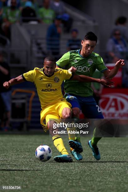 Ricardo Clark of Columbus Crew works against Kim Kee-hee in the second half during their game at CenturyLink Field on May 5, 2018 in Seattle,...