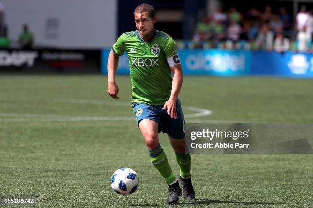 Osvaldo Alonso of Seattle Sounders dribbles with the ball in the second half against the Columbus Crew during their game at CenturyLink Field on May...