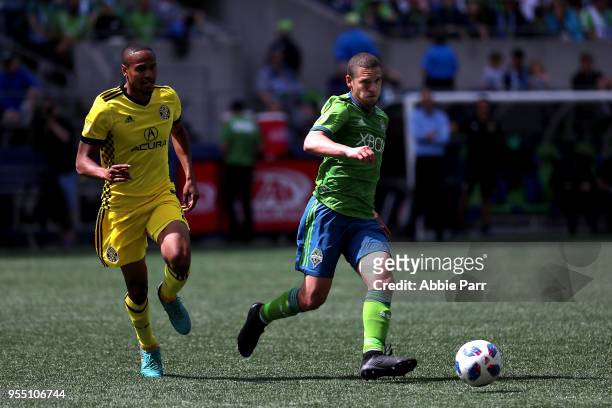 Osvaldo Alonso of Seattle Sounders dribbles with the ball in the second half against Ricardo Clark of Columbus Crew during their game at CenturyLink...