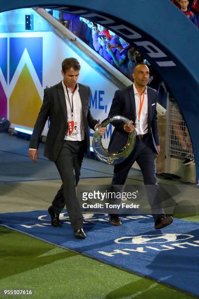 Archie Thompson and Joel Griffiths walk out with the A-League trophy during the 2018 A-League Grand Final match between the Newcastle Jets and the...