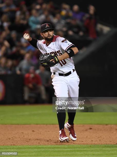 Deven Marrero of the Arizona Diamondbacks makes a running throw to first base against the Los Angeles Dodgers at Chase Field on May 2, 2018 in...