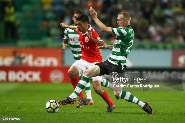 Benfica forward Raul Jimenez from Mexico vies with Sporting CP defender Jeremy Mathieu from France for the ball possession during the Portuguese...