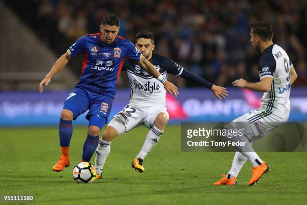 Dimitri Petratos of the Jets contests the ball with Stefan Nigro of the Victory during the 2018 A-League Grand Final match between the Newcastle Jets...