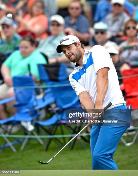 Peter Uihlein chips his ball onto the 18th fairway at Quail Hollow Club in Charlotte, N.C., during third-round action in the Wells Fargo Championship...