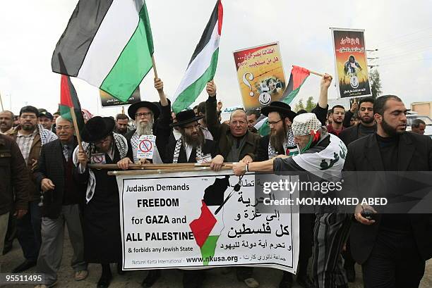 Members of Neturei Karta, a fringe ultra-Orthodox movement within the anti-Zionist bloc, Palestinians and foreign activists take part in a protest in...