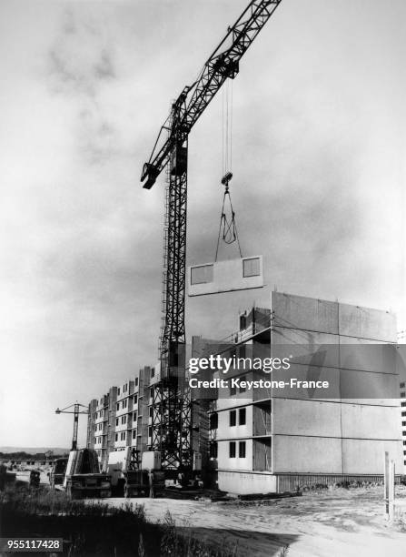 Pose d'un panneau vertical porté par une grue, à Nanterre, France.