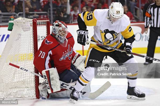 Goalie Braden Holtby of the Washington Capitals tends the net in front of Jake Guentzel of the Pittsburgh Penguins during the first period in Game...