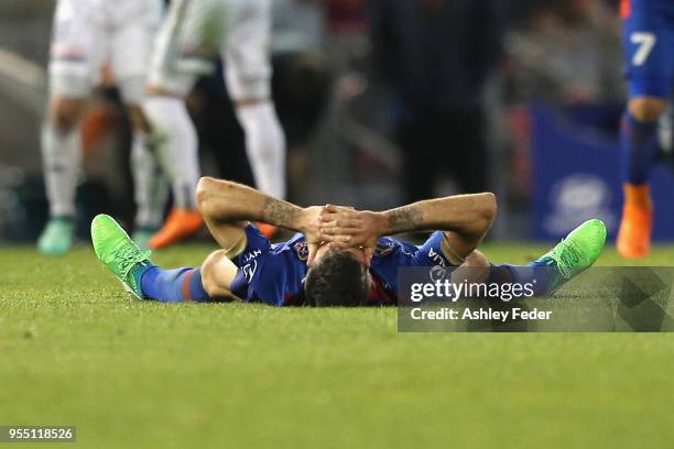 Jason Hoffman of the Jets lays on the ground dejected after losing during the 2018 A-League Grand Final match between the Newcastle Jets and the...