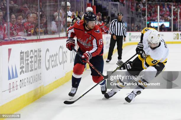 Nicklas Backstrom of the Washington Capitals and Brian Dumoulin of the Pittsburgh Penguins battle for the puck in the first period in Game Five of...