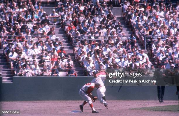 Don Blasingame of the Cincinnati Reds receives the ball as Harvey Kuenn of the San Francisco Giants slides during an MLB game on July 6, 1961 at...