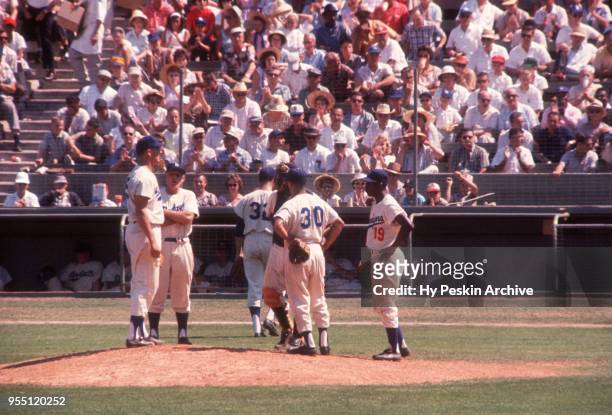 Pitching coach Clay Bryant of the Los Angeles Dodgers replaces pitcher Sandy Koufax with Don Drysdale as Jim Gilliam, Maury Wills and John Roseboro...