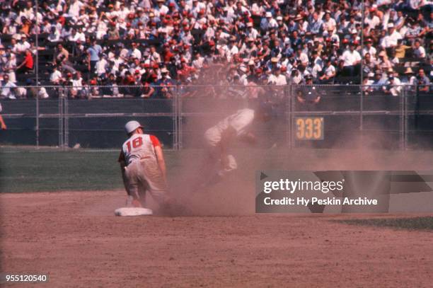 Gordy Coleman of the Cincinnati Reds is out at second base as Charlie Neal of the Los Angeles Dodgers tries to avoid the slide during an MLB game on...