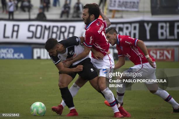 Nacional's Sebastian Rodriguez vies for the ball with Danubio's Nicolas Prieto during their Uruguayan Apertura tournament football match in...