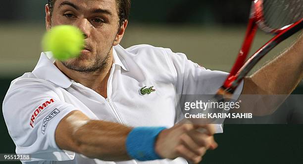 Swiss Stanislas Wawrinka returns to Robin Soderling of Sweden during the first day of the 250,000-dollar Capitala World Tennis Championship at Abu...