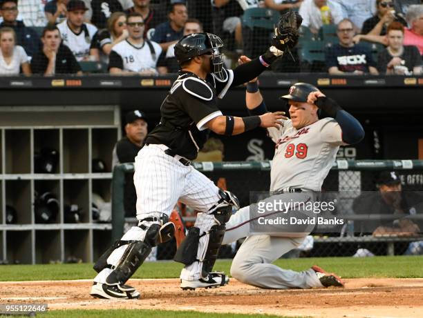 Logan Morrison of the Minnesota Twins is safe at home as Welington Castillo of the Chicago White Sox makes a late tag during the third inning on May...