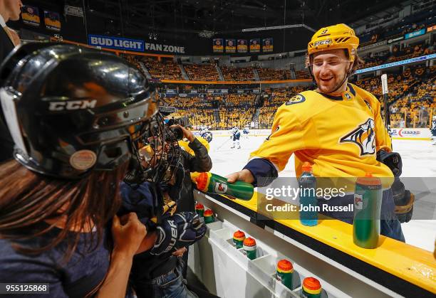 Filip Forsberg of the Nashville Predators teases a young fan during warmups prior to Game Five of the Western Conference Second Round against the...